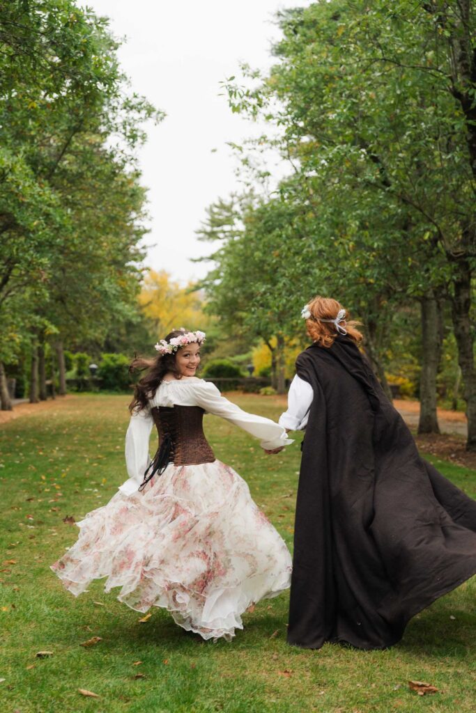 A Renaissance-inspired autumn engagement session at Skylands Manor and the New Jersey Botanical Gardens in Ringwood, NJ, featuring flower crowns, a wool cape, and romantic garden portraits before a Stone House wedding.