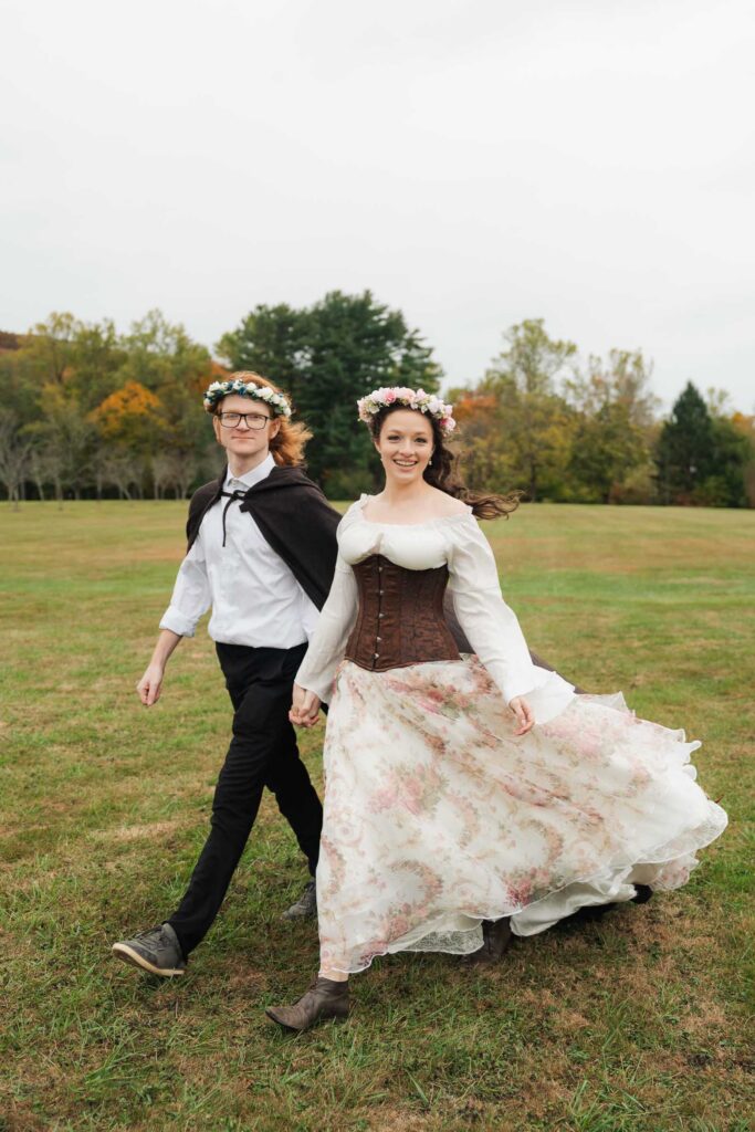 A Renaissance-inspired autumn engagement session at Skylands Manor and the New Jersey Botanical Gardens in Ringwood, NJ, featuring flower crowns, a wool cape, and romantic garden portraits before a Stone House wedding.