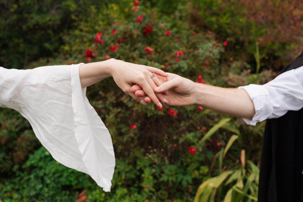 A Renaissance-inspired autumn engagement session at Skylands Manor and the New Jersey Botanical Gardens in Ringwood, NJ, featuring flower crowns, a wool cape, and romantic garden portraits before a Stone House wedding.