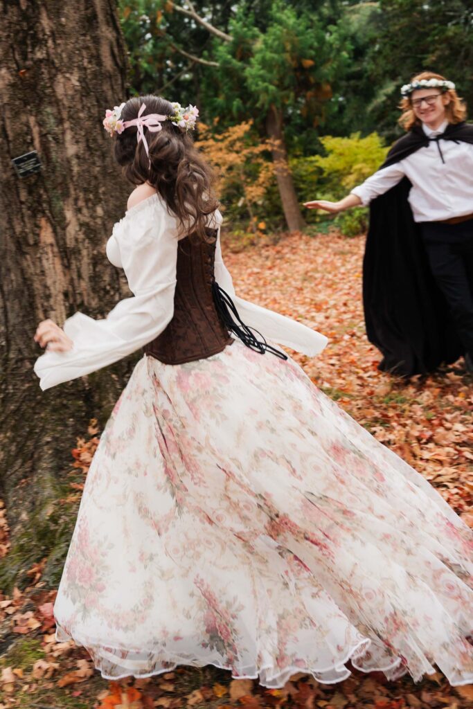 A Renaissance-inspired autumn engagement session at Skylands Manor and the New Jersey Botanical Gardens in Ringwood, NJ, featuring flower crowns, a wool cape, and romantic garden portraits before a Stone House wedding.