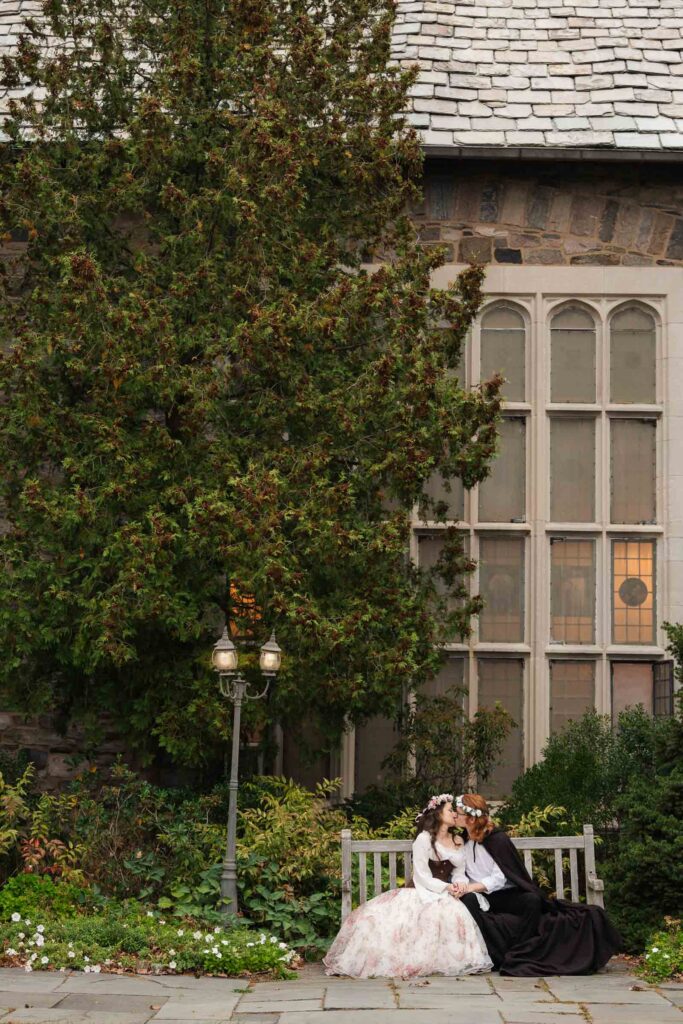 A Renaissance-inspired autumn engagement session at Skylands Manor and the New Jersey Botanical Gardens in Ringwood, NJ, featuring flower crowns, a wool cape, and romantic garden portraits before a Stone House wedding.