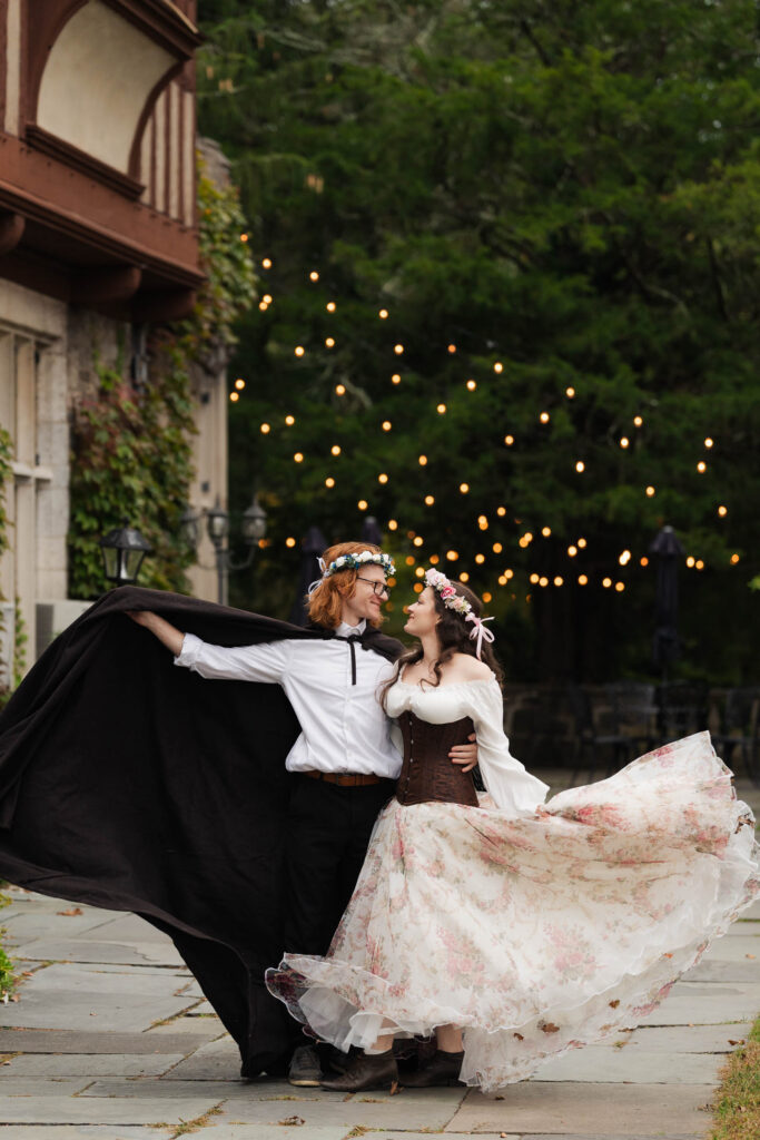 A Renaissance-inspired autumn engagement session at Skylands Manor and the New Jersey Botanical Gardens in Ringwood, NJ, featuring flower crowns, a wool cape, and romantic garden portraits before a Stone House wedding.