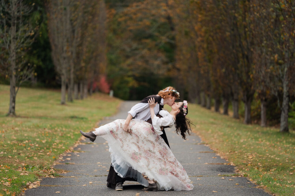 A Renaissance-inspired autumn engagement session at Skylands Manor and the New Jersey Botanical Gardens in Ringwood, NJ, featuring flower crowns, a wool cape, and romantic garden portraits before a Stone House wedding.