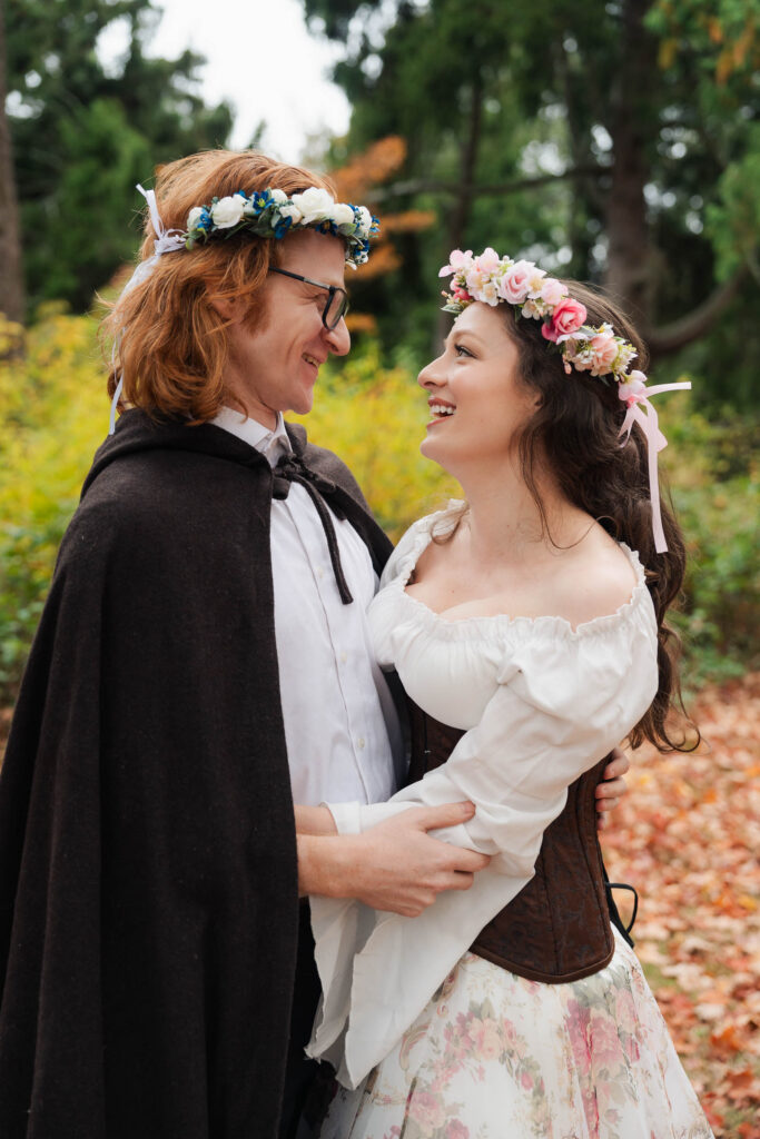 A Renaissance-inspired autumn engagement session at Skylands Manor and the New Jersey Botanical Gardens in Ringwood, NJ, featuring flower crowns, a wool cape, and romantic garden portraits before a Stone House wedding.