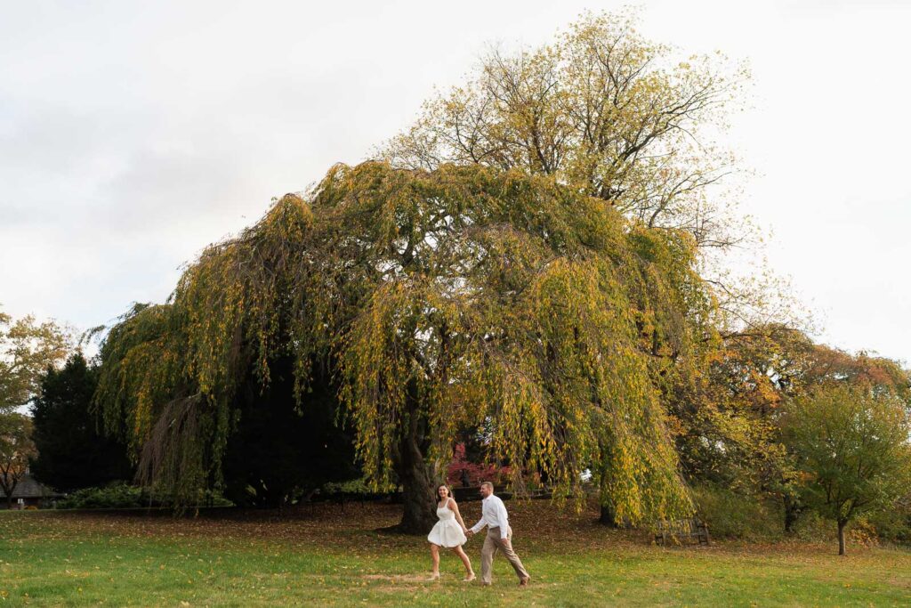 A vintage-inspired late autumn engagement session at Skylands Manor and the New Jersey Botanical Gardens in Ringwood, NJ, featuring fall foliage, classic outfits, and romantic garden portraits.