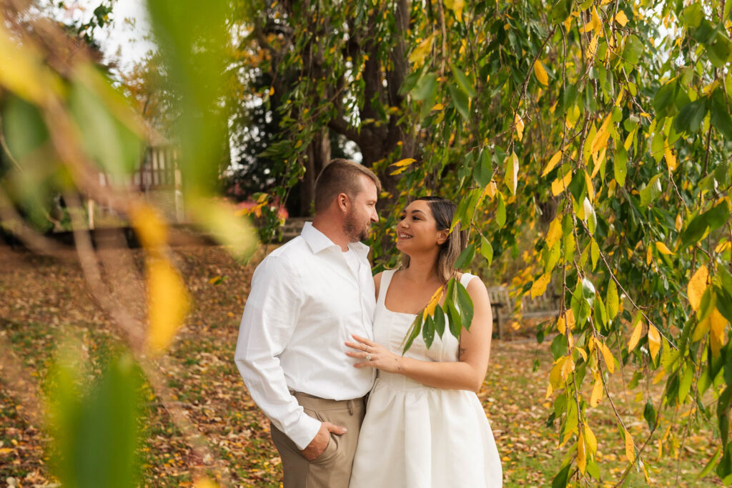 A vintage-inspired late autumn engagement session at Skylands Manor and the New Jersey Botanical Gardens in Ringwood, NJ, featuring fall foliage, classic outfits, and romantic garden portraits.