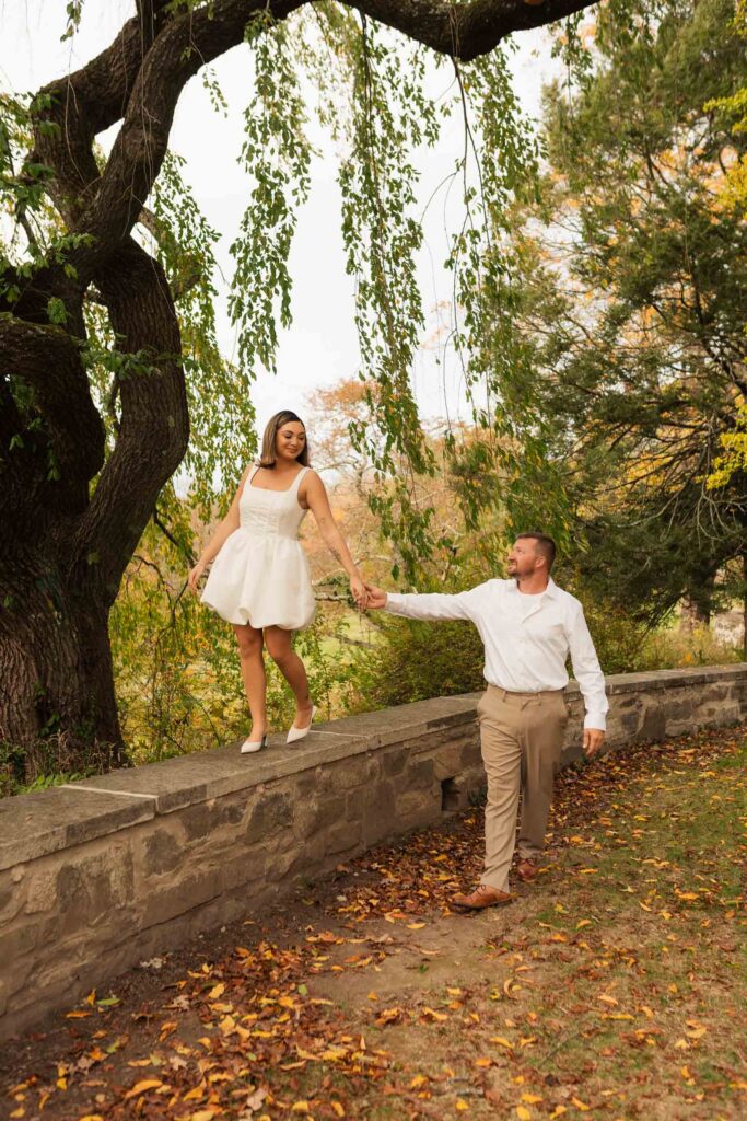 A vintage-inspired late autumn engagement session at Skylands Manor and the New Jersey Botanical Gardens in Ringwood, NJ, featuring fall foliage, classic outfits, and romantic garden portraits.