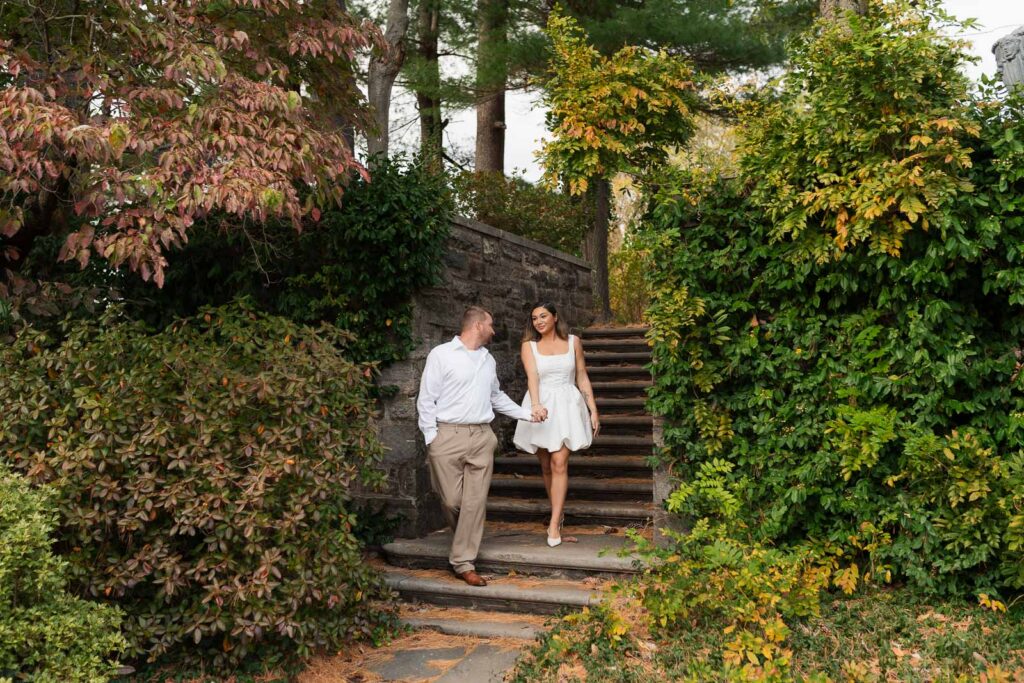 A vintage-inspired late autumn engagement session at Skylands Manor and the New Jersey Botanical Gardens in Ringwood, NJ, featuring fall foliage, classic outfits, and romantic garden portraits.