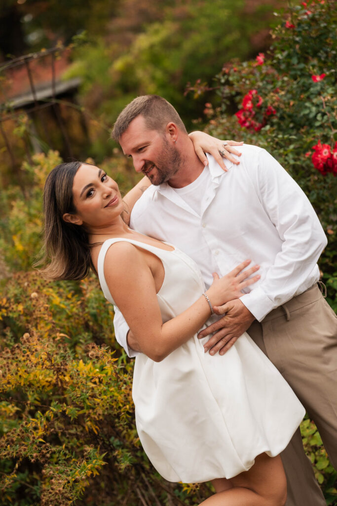 A vintage-inspired late autumn engagement session at Skylands Manor and the New Jersey Botanical Gardens in Ringwood, NJ, featuring fall foliage, classic outfits, and romantic garden portraits.