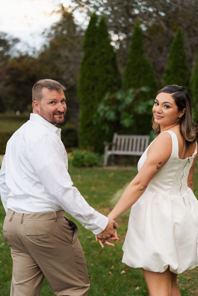 A vintage-inspired late autumn engagement session at Skylands Manor and the New Jersey Botanical Gardens in Ringwood, NJ, featuring fall foliage, classic outfits, and romantic garden portraits.