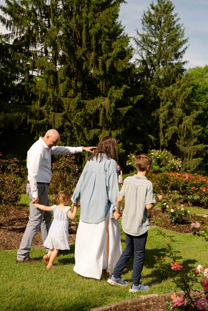 A family photoshoot in a rose garden on a sunny spring afternoon in Bloomfield New Jersey.