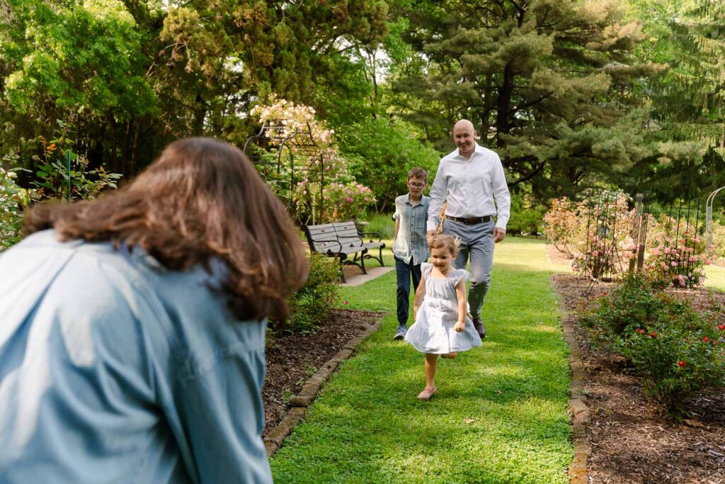 A family photoshoot in a rose garden on a sunny spring afternoon in Bloomfield New Jersey.