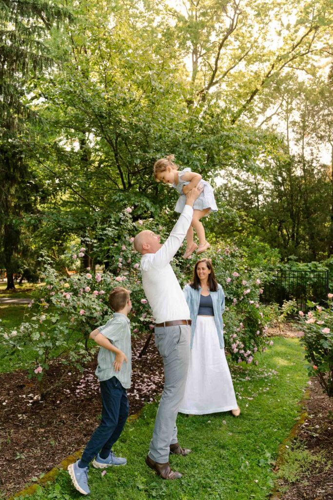 A family photoshoot in Brookdale Park Rose Garden's rose garden on a sunny spring afternoon in Bloomfield New Jersey.