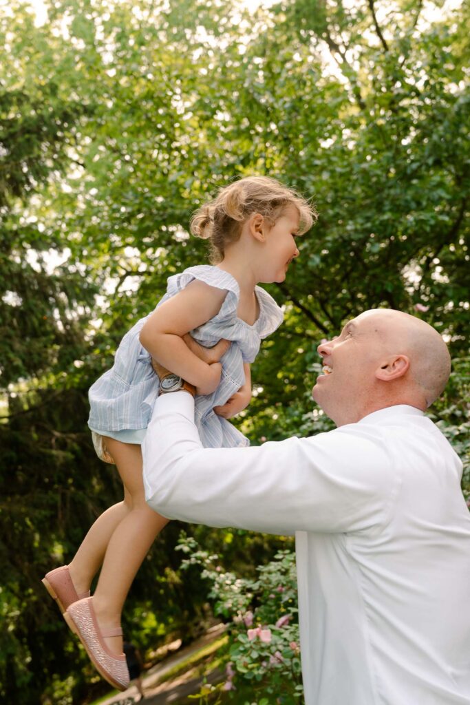 A family photoshoot in a rose garden on a sunny spring afternoon in Bloomfield New Jersey.
