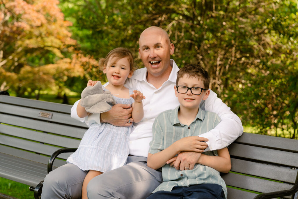A family photoshoot in a rose garden on a sunny spring afternoon in Bloomfield New Jersey.