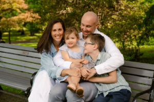 A family photoshoot in a rose garden on a sunny spring afternoon in Bloomfield New Jersey.