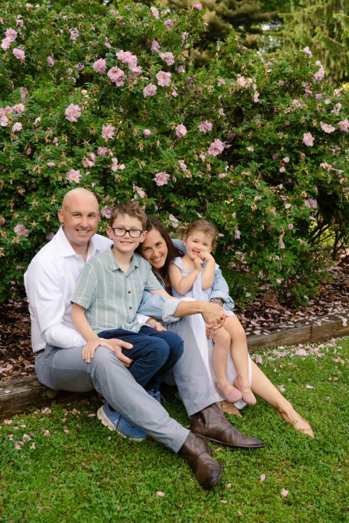 A family photoshoot in a rose garden on a sunny spring afternoon in Bloomfield New Jersey.