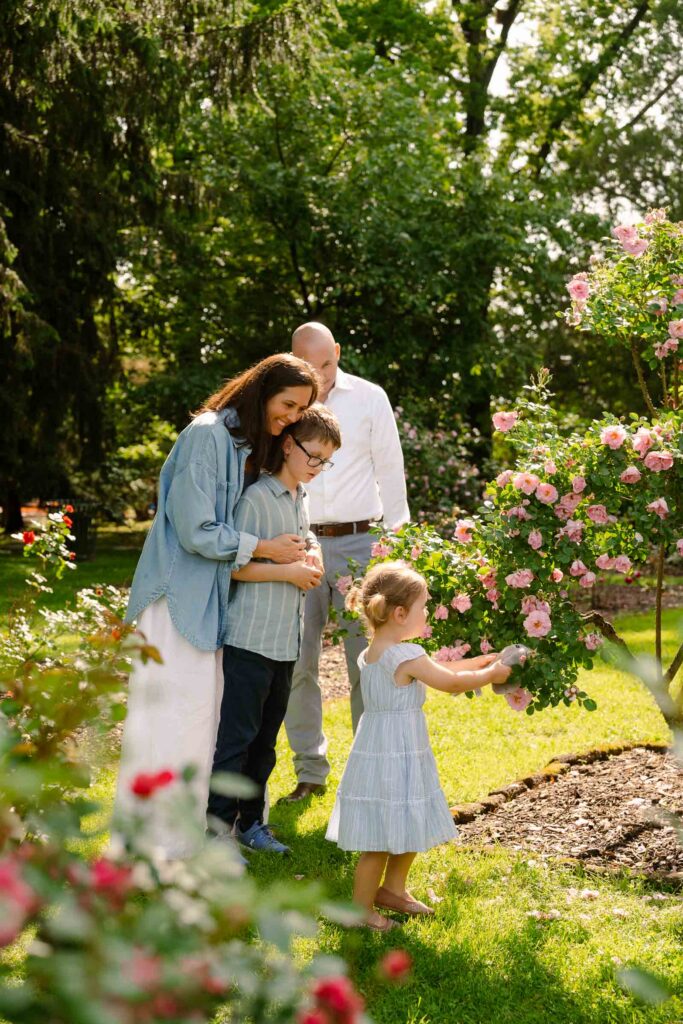 A family photoshoot in Brookdale Park Rose Garden's rose garden on a sunny spring afternoon in Bloomfield New Jersey.