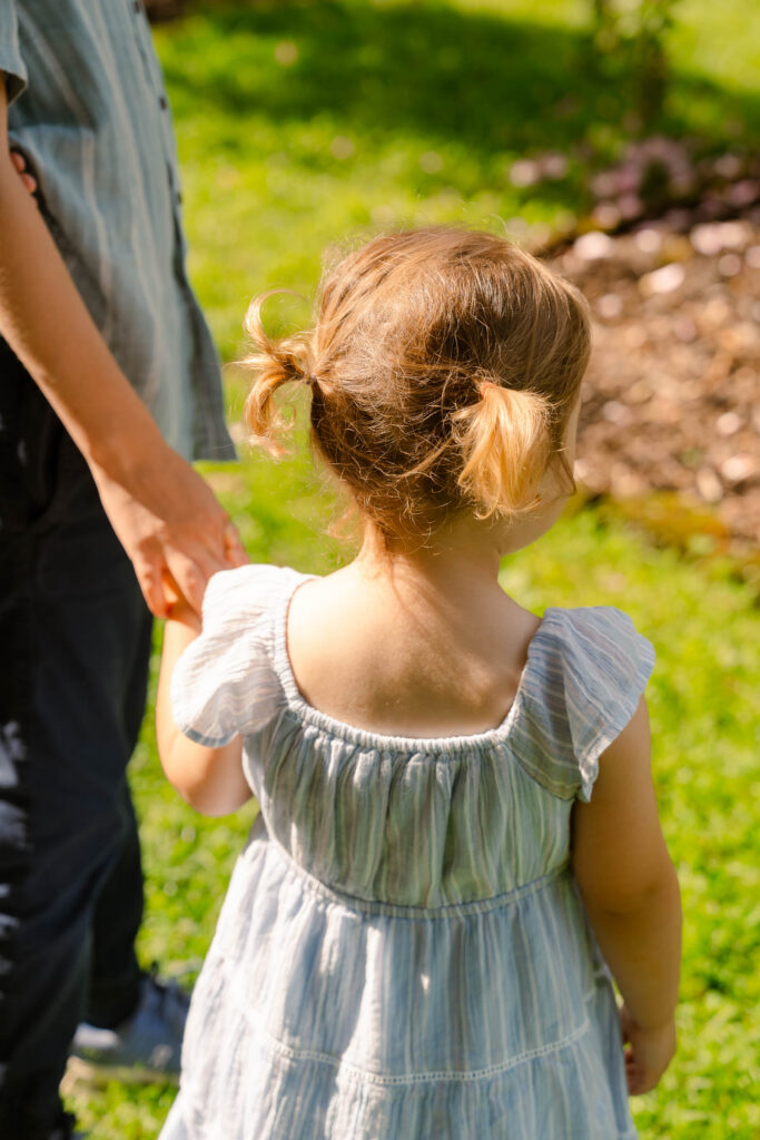 A family photoshoot in a rose garden on a sunny spring afternoon in Bloomfield New Jersey.